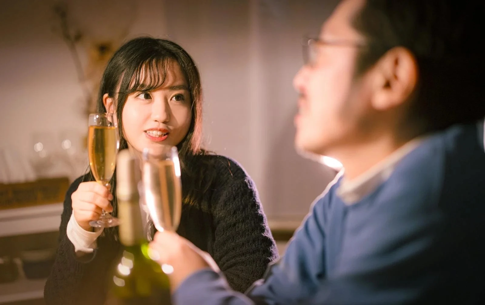 グラスを手に乾杯し見つめ合う女性と男性